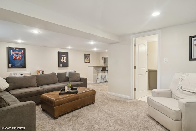 living room featuring baseboards, recessed lighting, and light colored carpet