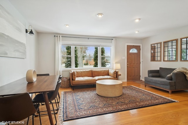 living area featuring recessed lighting, a wealth of natural light, and wood finished floors