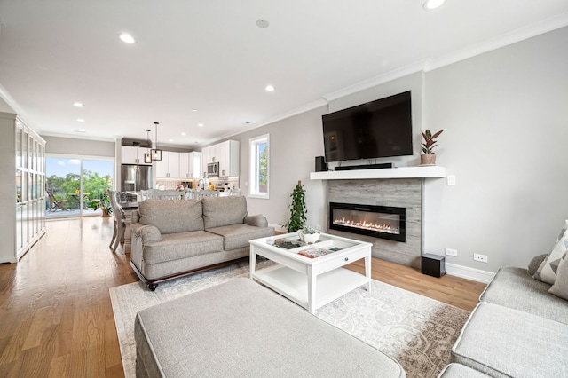 7230 W Belden Ave Unit 3, Elmwood Park, IL 60707 - living room featuring ornamental molding, recessed lighting, light wood-type flooring, baseboards, and a glass covered fireplace