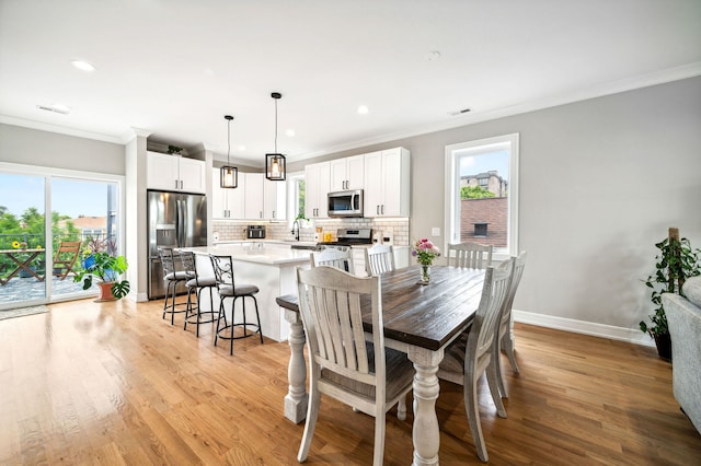 7230 W Belden Ave Unit 3, Elmwood Park, IL 60707 - dining room featuring ornamental molding, plenty of natural light, light wood finished floors, baseboards, and recessed lighting