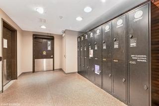 interior space featuring baseboards, mail area, and a package area