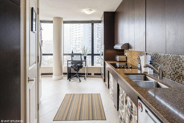 kitchen with light tile patterned flooring, plenty of natural light, and a sink