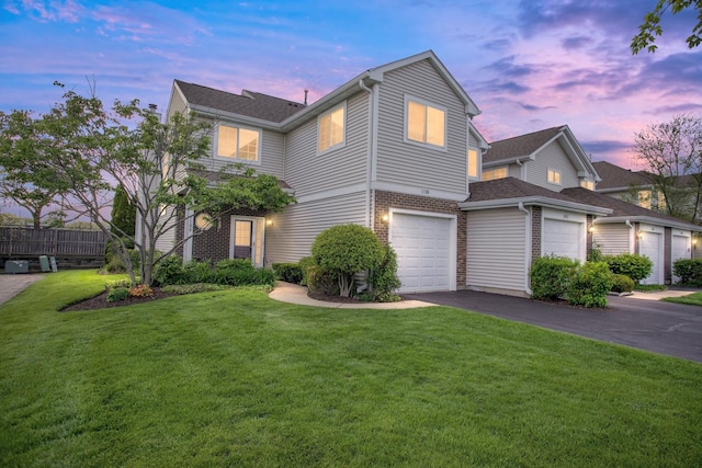 1100 E Cambria Ln, Lombard, IL 60148 - traditional-style house with asphalt driveway, a front yard, a garage, and brick siding
