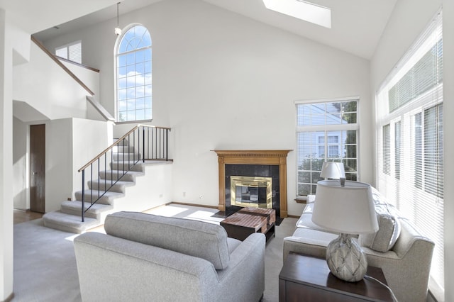 1100 E Cambria Ln, Lombard, IL 60148 - carpeted living room with high vaulted ceiling, a skylight, stairway, plenty of natural light, and a tiled fireplace
