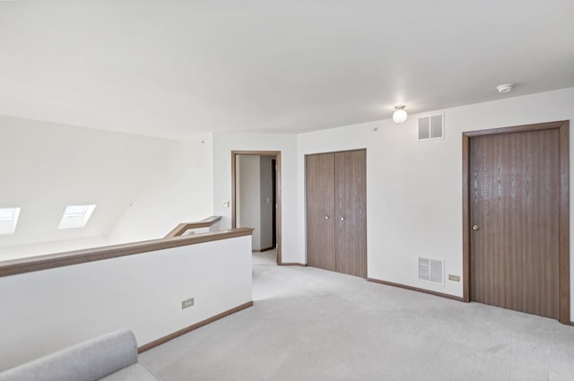 1100 E Cambria Ln, Lombard, IL 60148 - spare room with light carpet, a smoke detector, baseboards, and a skylight