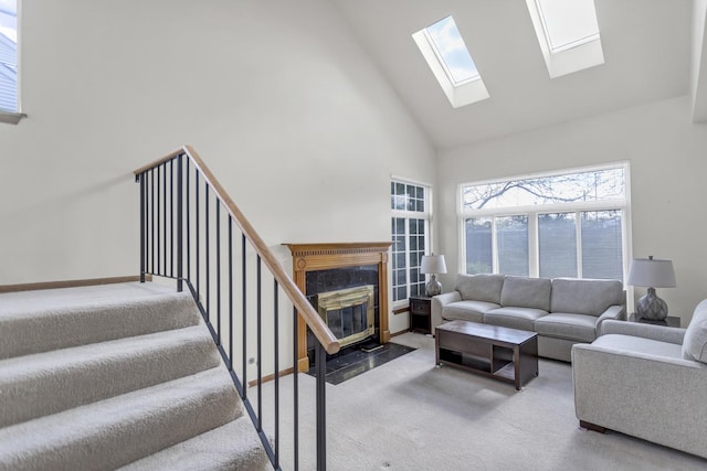 1100 E Cambria Ln, Lombard, IL 60148 - carpeted living room featuring high vaulted ceiling, a skylight, stairway, and baseboards