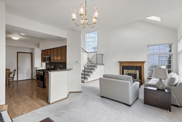 1100 E Cambria Ln, Lombard, IL 60148 - living room with stairway, a chandelier, a tiled fireplace, high vaulted ceiling, and light wood-type flooring