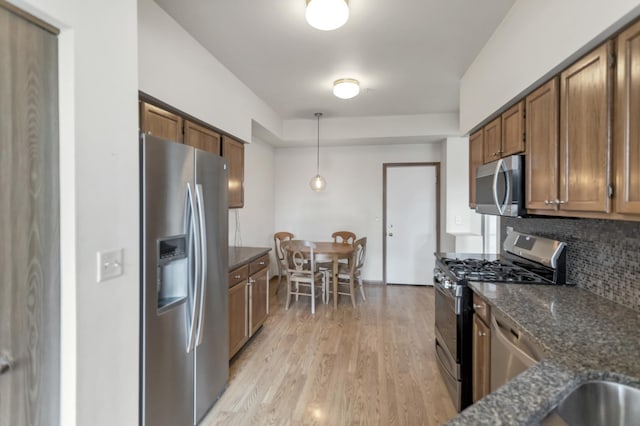 1100 E Cambria Ln, Lombard, IL 60148 - kitchen with appliances with stainless steel finishes, tasteful backsplash, brown cabinets, light wood finished floors, and pendant lighting