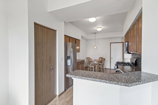 1100 E Cambria Ln, Lombard, IL 60148 - kitchen with appliances with stainless steel finishes, a peninsula, brown cabinetry, and light wood-style flooring