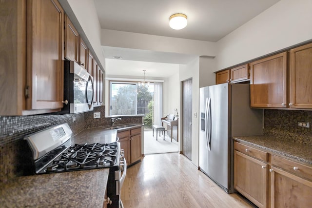 1100 E Cambria Ln, Lombard, IL 60148 - kitchen with stainless steel appliances, a sink, light wood-style floors, brown cabinetry, and a chandelier