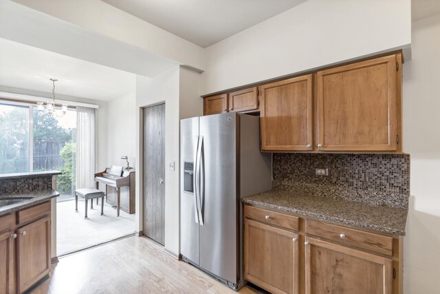 1100 E Cambria Ln, Lombard, IL 60148 - kitchen with stainless steel fridge, light wood-style flooring, brown cabinets, tasteful backsplash, and dark stone countertops