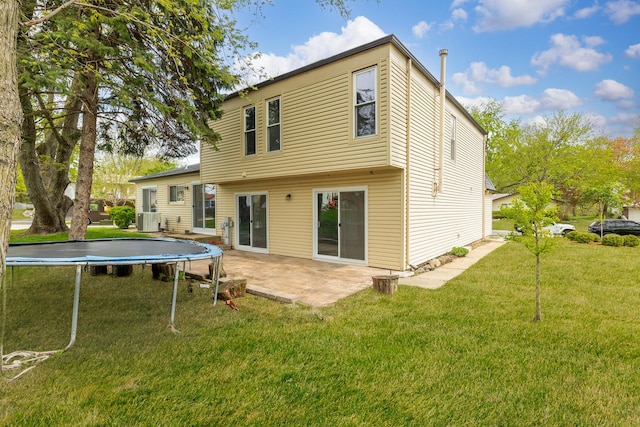 160 Camelot Way, Bolingbrook, IL 60440 - back of property featuring a lawn, central AC unit, a patio area, and a trampoline