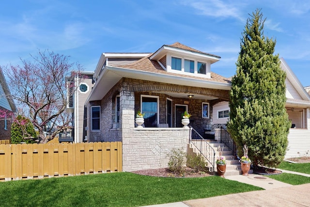5650 W Grace St, Chicago, IL 60634 - view of front of property with a porch, a front yard, fence, and stone siding