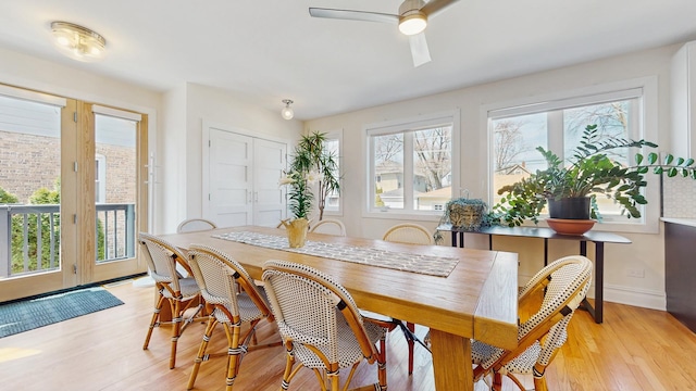 5650 W Grace St, Chicago, IL 60634 - dining area featuring baseboards, plenty of natural light, a ceiling fan, and light wood finished floors
