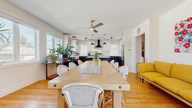 5650 W Grace St, Chicago, IL 60634 - dining room with light wood-style floors, baseboards, and a ceiling fan