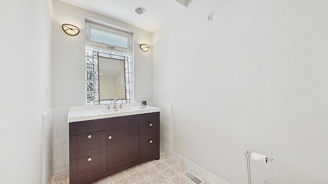 5650 W Grace St, Chicago, IL 60634 - bathroom featuring baseboards, visible vents, and vanity