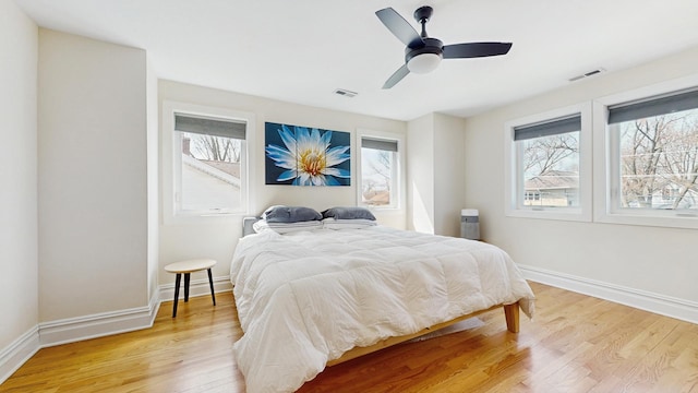 5650 W Grace St, Chicago, IL 60634 - bedroom with baseboards, multiple windows, light wood-type flooring, and visible vents