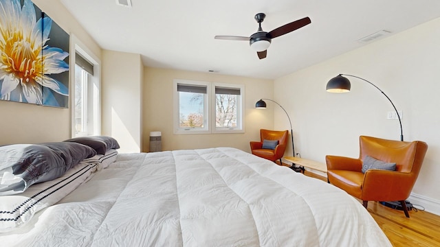 5650 W Grace St, Chicago, IL 60634 - bedroom with visible vents, ceiling fan, wood finished floors, and multiple windows