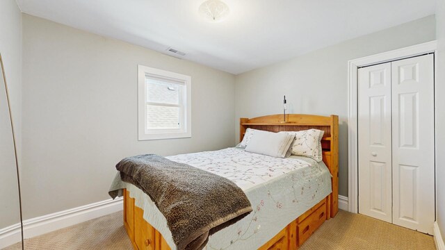 5650 W Grace St, Chicago, IL 60634 - bedroom featuring visible vents, baseboards, a closet, and light carpet