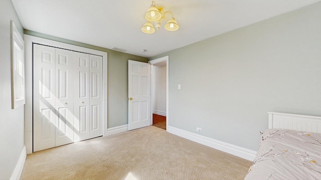 5650 W Grace St, Chicago, IL 60634 - unfurnished bedroom with carpet floors, baseboards, a closet, and a chandelier