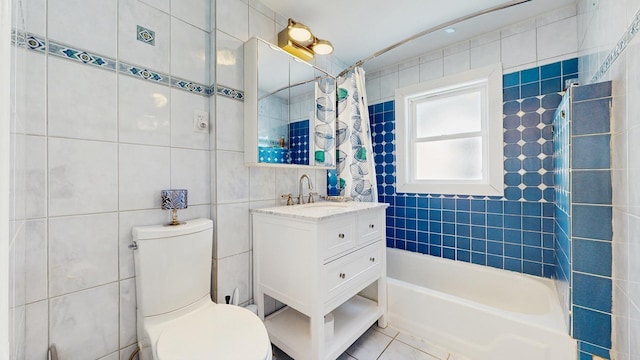 5650 W Grace St, Chicago, IL 60634 - bathroom featuring vanity, toilet, tile walls, and shower / tub combo with curtain