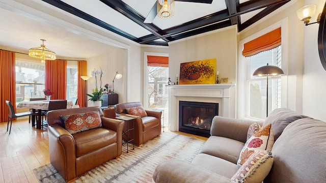 5650 W Grace St, Chicago, IL 60634 - living area with a glass covered fireplace, plenty of natural light, hardwood / wood-style flooring, and a notable chandelier