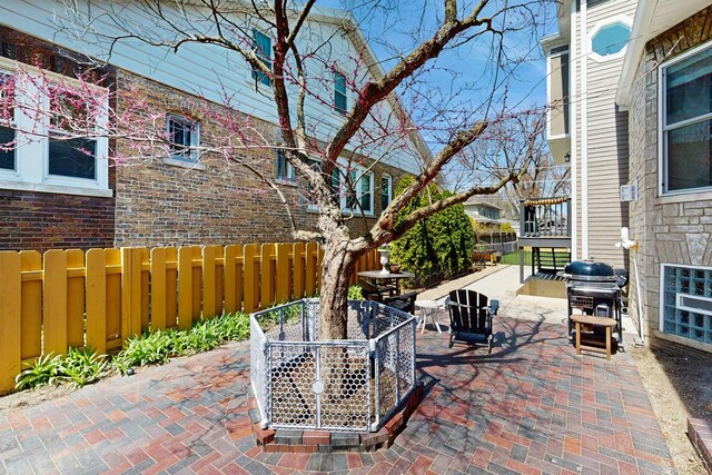 5650 W Grace St, Chicago, IL 60634 - view of patio / terrace with a grill, fence, and outdoor dining space