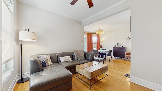 5650 W Grace St, Chicago, IL 60634 - living area with visible vents, ornamental molding, light wood-style floors, baseboards, and ceiling fan