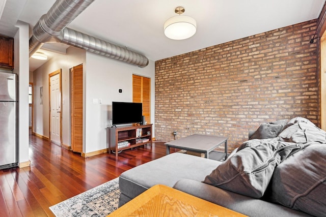 1247 W Roscoe St Unit 2, Chicago, IL 60657 - living room featuring brick wall, wood finished floors, and baseboards