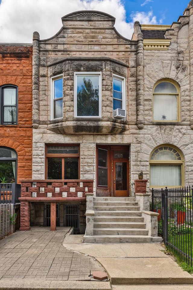 4444 S Berkeley Ave, Chicago, IL 60653 - view of front of house with fence, stone siding, and cooling unit