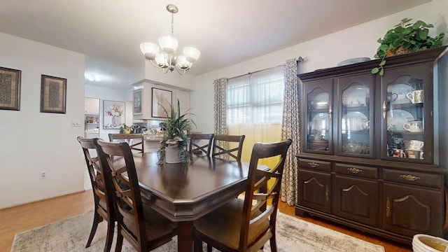 1309 Eureka St, Urbana, IL 61801 - dining area with a chandelier and light wood-style flooring