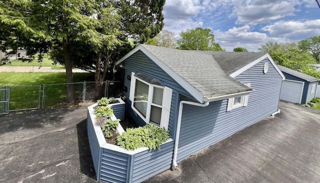 1309 Eureka St, Urbana, IL 61801 - view of side of home featuring fence and a shingled roof