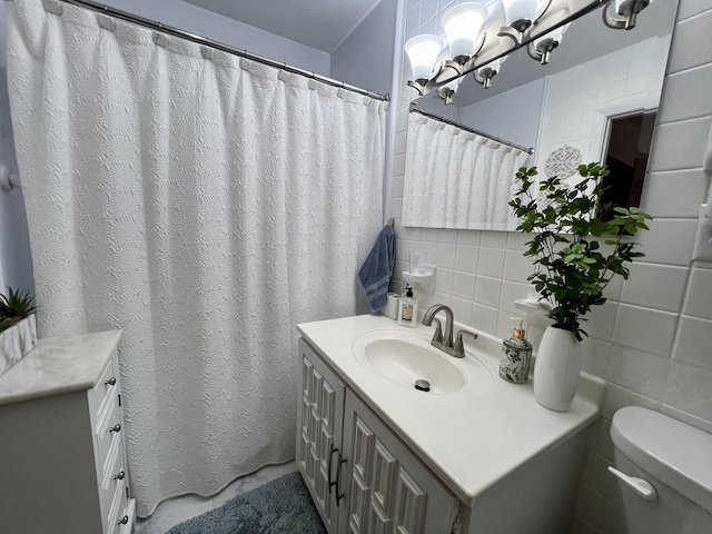 1309 Eureka St, Urbana, IL 61801 - bathroom with vanity, toilet, tile walls, and backsplash