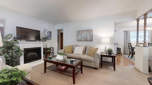 1309 Eureka St, Urbana, IL 61801 - living area featuring a fireplace with raised hearth and light colored carpet