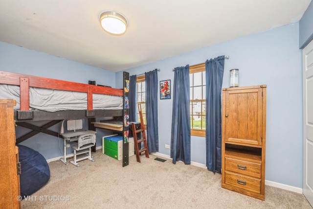 carpeted bedroom featuring baseboards