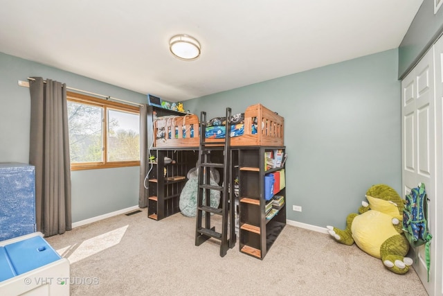 carpeted bedroom featuring baseboards