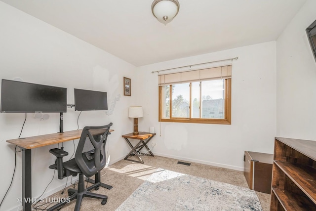 carpeted office space featuring baseboards