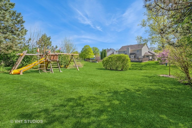 view of grassy yard with a playground