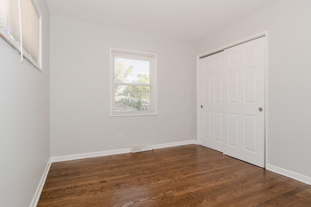 15413 Dobson Ave, Dolton, IL 60419 - unfurnished bedroom with visible vents, dark wood finished floors, baseboards, and a closet