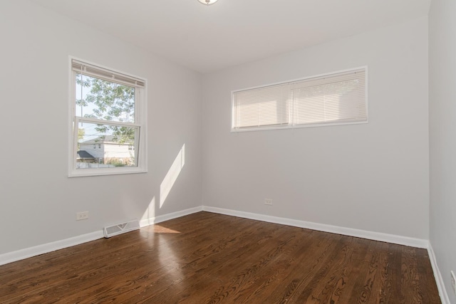 15413 Dobson Ave, Dolton, IL 60419 - spare room with baseboards, visible vents, and dark wood finished floors