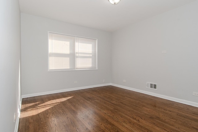 15413 Dobson Ave, Dolton, IL 60419 - empty room with dark wood-style flooring, baseboards, and visible vents