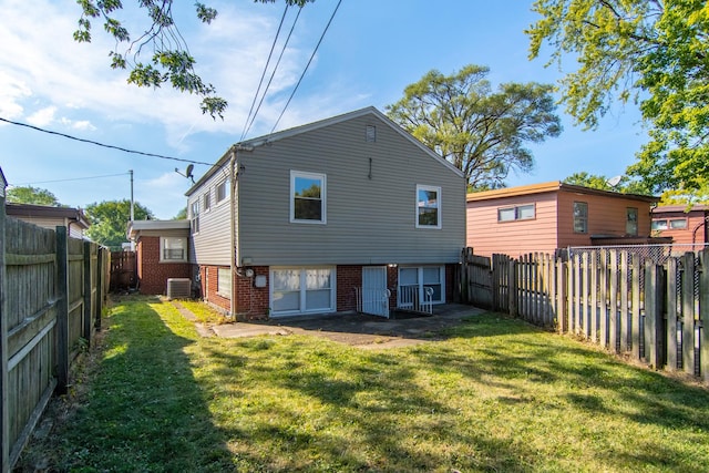 15413 Dobson Ave, Dolton, IL 60419 - rear view of house featuring a yard, brick siding, central AC unit, and a fenced backyard