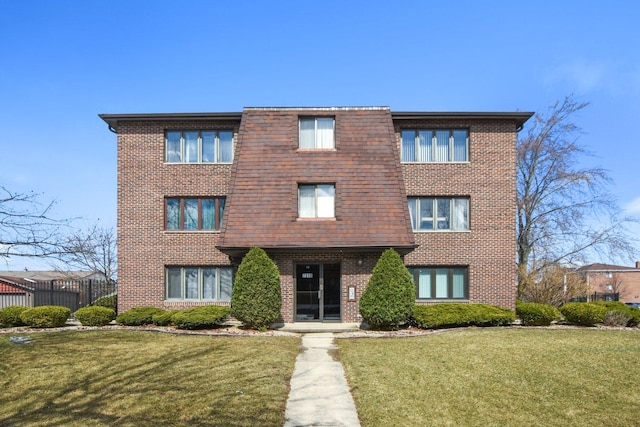 7310 Tiffany Dr Unit 2B, Orland Park, IL 60462 - view of front facade with brick siding, fence, and a front lawn