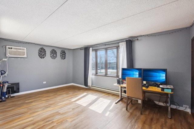7310 Tiffany Dr Unit 2B, Orland Park, IL 60462 - home office featuring wood finished floors, baseboards, a textured ceiling, a wall mounted AC, and a baseboard radiator