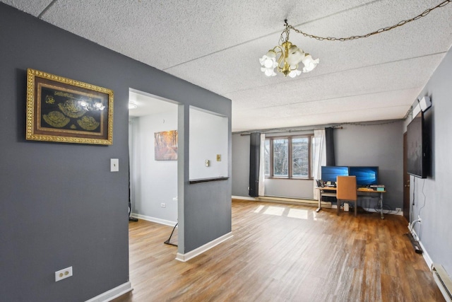 7310 Tiffany Dr Unit 2B, Orland Park, IL 60462 - interior space with a textured ceiling, wood finished floors, baseboards, a baseboard heating unit, and an inviting chandelier