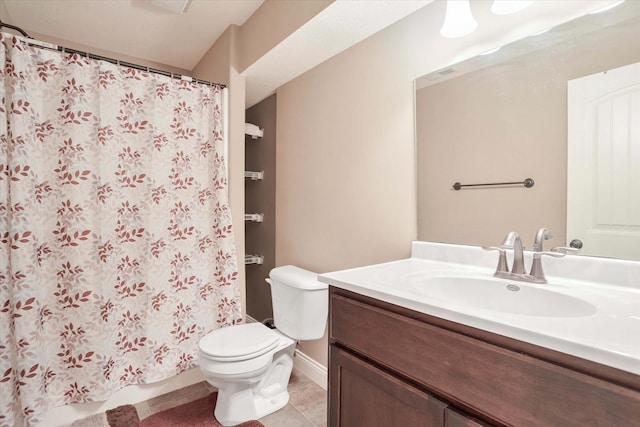 bathroom featuring toilet, tile patterned flooring, vanity, and curtained shower