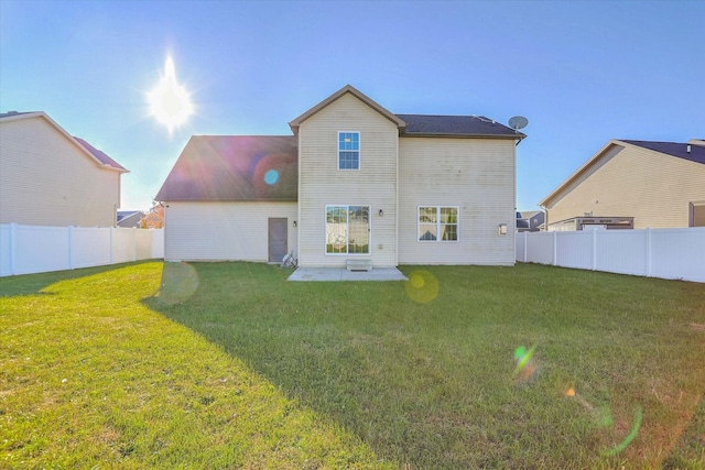 back of property with a yard, a fenced backyard, and a patio