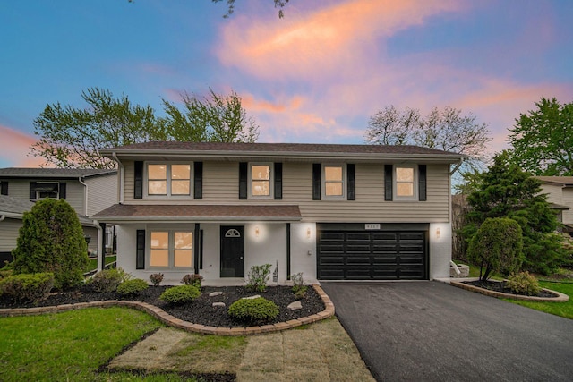 traditional home featuring a garage, driveway, and a porch