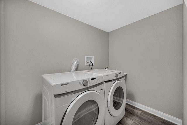 laundry area with separate washer and dryer, baseboards, and dark wood-style floors
