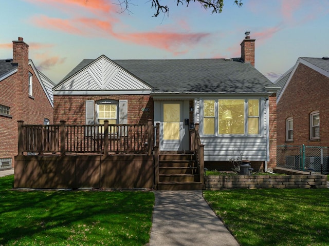 11321 S Drake Ave, Chicago, IL 60655 - view of front of house with a lawn, brick siding, fence, and a shingled roof